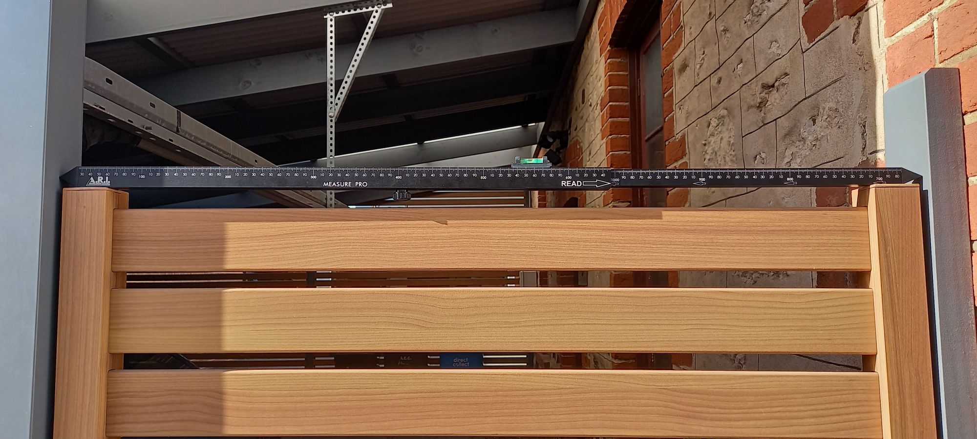showing the black Measure Pro taking the inside measurement for a gate.