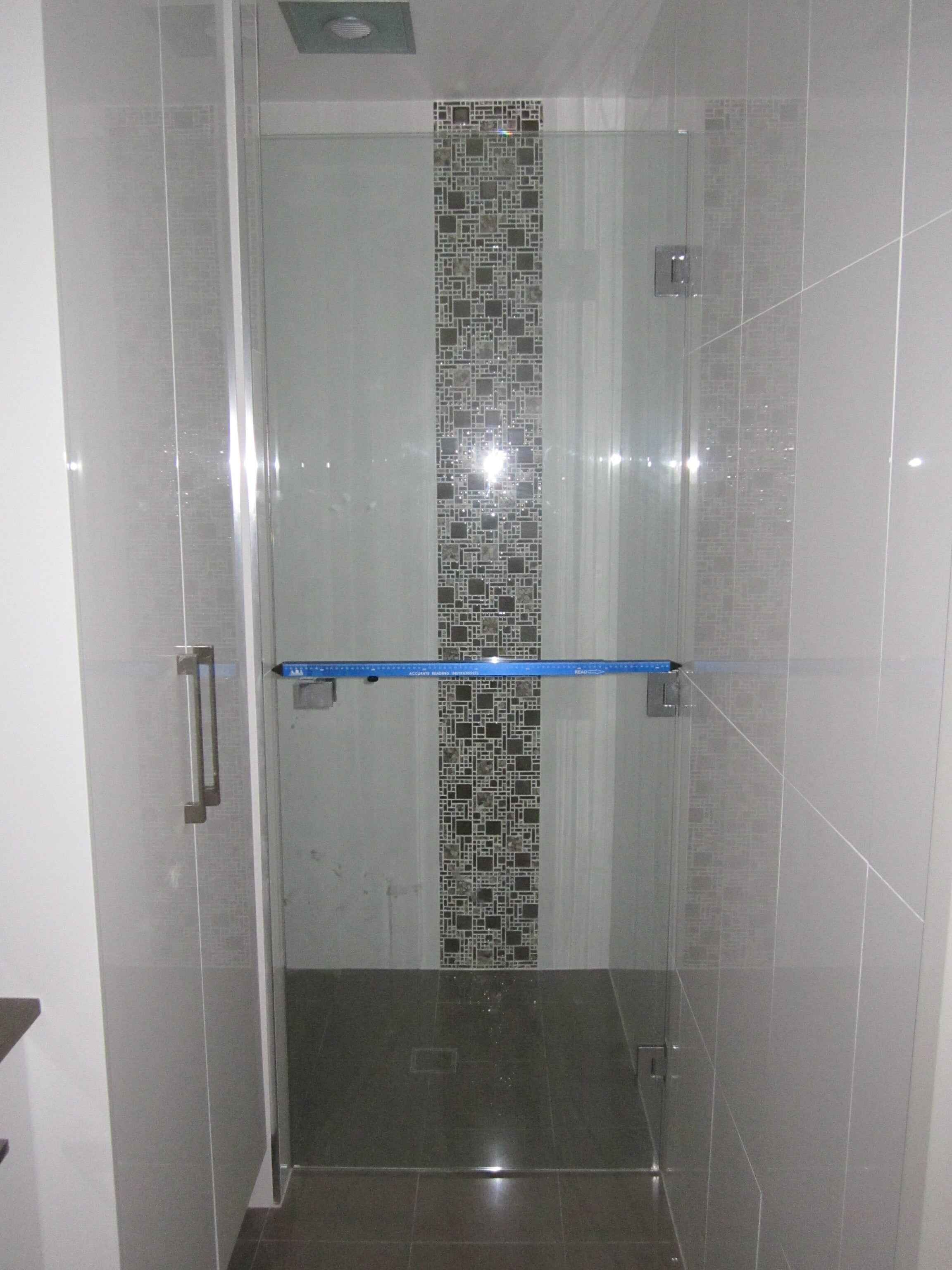 Showing the blue Measure Pro taking the inside measurement for a shower screen.